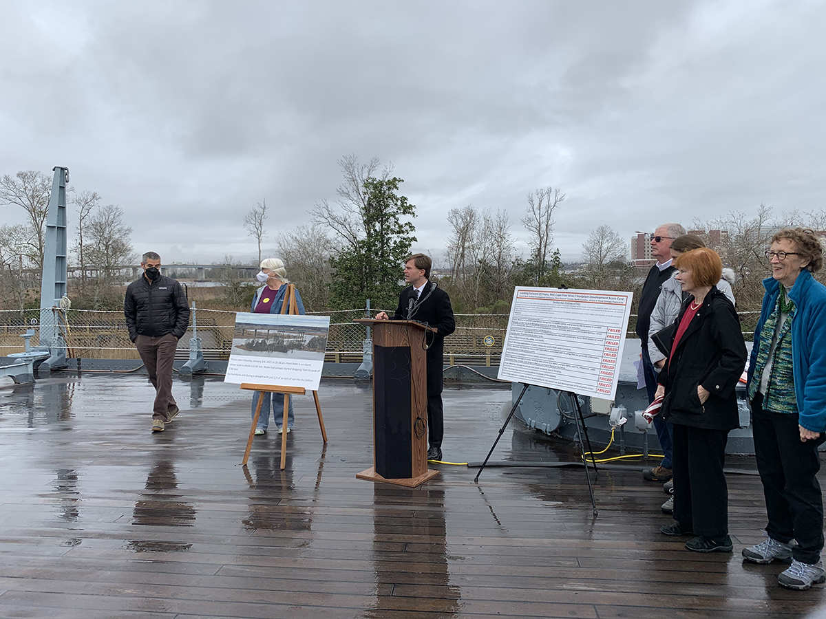 Wilmington Historic Foundation Executive Director Travis Gilbert, at a podium on the deck of the USS North Carolina in Wilmington Wednesday, kicks off a press conference addressing concerns about a proposed development just south of the battleship. A coalition of environmental and historic preservation groups, including the foundation, oppose a developer's request to create a new zoning district along the western bank of the Cape Fear River and adjacent to downtown Wilmington.
 Photo: Trista Talton