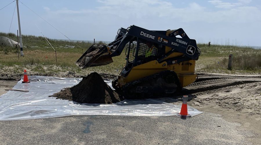 A contractor removes soil from the Buxton site in this Corps photo.
