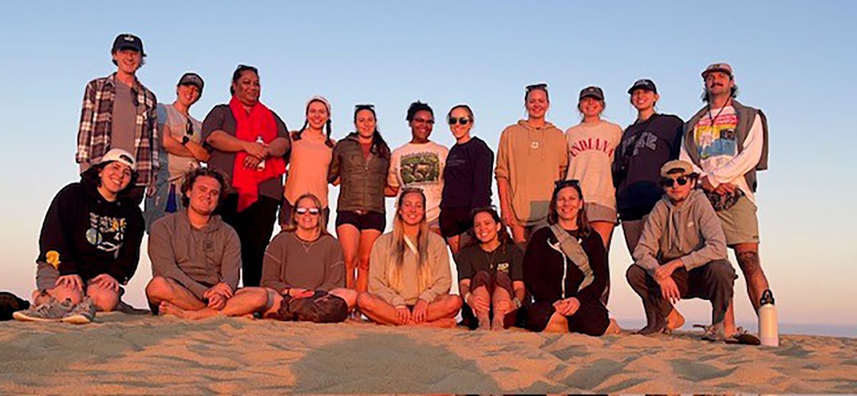 Past participants in the University of North Carolina Wilmington the North Carolina coastal issues and experience class pose as a group in this university-provided photo.